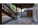 Backyard patio beneath stairs leading to an upper deck, featuring flagstone and wood steps, surrounded by mature trees at 1048 Standard Ne Dr, Brookhaven, GA 30319