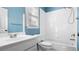 Well-lit bathroom with blue walls featuring a shower-tub combo with white tile surround at 1048 Standard Ne Dr, Brookhaven, GA 30319