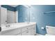 Well-lit bathroom with blue walls featuring a double vanity and a shower-tub combo at 1048 Standard Ne Dr, Brookhaven, GA 30319