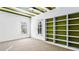 Bright bedroom featuring neutral carpet, custom shelving unit with green accent wall and ceiling fan at 1048 Standard Ne Dr, Brookhaven, GA 30319