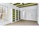 Spacious bedroom features neutral carpet, natural light and custom shelving unit with green accent wall at 1048 Standard Ne Dr, Brookhaven, GA 30319