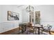 Elegant dining room featuring modern lighting, wainscoting, and hardwood floors at 1048 Standard Ne Dr, Brookhaven, GA 30319