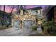 Stone-clad home with a two-car garage, manicured shrubs, and a driveway leading to the garages at 1048 Standard Ne Dr, Brookhaven, GA 30319