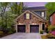Charming home featuring a stone facade, two-car garage, and a beautifully landscaped front yard at 1048 Standard Ne Dr, Brookhaven, GA 30319