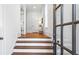 Bright entryway with hardwood floors and a staircase, illuminated by natural light from a glass-paned front door at 1048 Standard Ne Dr, Brookhaven, GA 30319