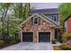 Charming two-story home featuring stone accents, a two-car garage, and professionally landscaped yard at 1048 Standard Ne Dr, Brookhaven, GA 30319
