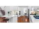 Well-lit kitchen with stainless appliances, white cabinets, and hardwood floors at 1048 Standard Ne Dr, Brookhaven, GA 30319