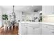 Bright, modern kitchen with white cabinets, hardwood floors, a farmhouse sink, and a view of the dining area at 1048 Standard Ne Dr, Brookhaven, GA 30319