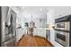 Modern kitchen features stainless steel appliances, white cabinetry, and a view into the breakfast nook at 1048 Standard Ne Dr, Brookhaven, GA 30319