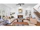 Bright living room featuring built-in bookcases, a cozy fireplace, and hardwood flooring at 1048 Standard Ne Dr, Brookhaven, GA 30319