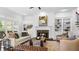 Inviting living room with fireplace, built-in bookshelves, and large windows providing natural light at 1048 Standard Ne Dr, Brookhaven, GA 30319