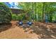Charming backyard sitting area with a fire pit, perfect for outdoor relaxation and entertaining at 2396 Midvale Cir, Tucker, GA 30084