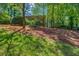 Lush backyard featuring blue hammock chairs in a wooded, secluded setting at 2396 Midvale Cir, Tucker, GA 30084