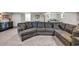 Spacious basement featuring a large sectional sofa and entertainment area with a wet bar and bedroom in the background at 2396 Midvale Cir, Tucker, GA 30084