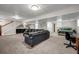 Large finished basement with a sprawling seating area, wet bar, work station and bedroom area at 2396 Midvale Cir, Tucker, GA 30084