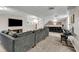 Basement media area featuring a plush sofa, large-screen TV, and convenient wet bar for entertaining at 2396 Midvale Cir, Tucker, GA 30084