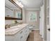 Bright bathroom with double sinks, granite countertops, and a tiled shower at 2396 Midvale Cir, Tucker, GA 30084