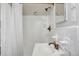 Bathroom with white tile, updated fixtures, and a shower with curtain at 2396 Midvale Cir, Tucker, GA 30084