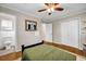 Comfortable bedroom with hardwood floors, ceiling fan, and closet space at 2396 Midvale Cir, Tucker, GA 30084