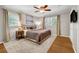 Comfortable bedroom with neutral tones, ceiling fan, and plush carpet at 2396 Midvale Cir, Tucker, GA 30084