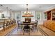 Dining area features a dark wood table set, a brick fireplace and hardwood floors at 2396 Midvale Cir, Tucker, GA 30084