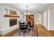 Well-lit dining area with fireplace, built-in display cabinet and hardwood floors at 2396 Midvale Cir, Tucker, GA 30084