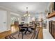 Dining area features a classic table and chairs, fireplace and a view into the kitchen at 2396 Midvale Cir, Tucker, GA 30084