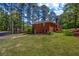 Charming red brick home with lush green lawn and mature trees at 2396 Midvale Cir, Tucker, GA 30084