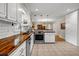 Updated kitchen featuring white subway tile backsplash, wood countertops, and stainless steel appliances at 2396 Midvale Cir, Tucker, GA 30084