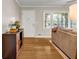 Open-concept living room features hardwood floors, natural light, and a stylish console table at 2396 Midvale Cir, Tucker, GA 30084