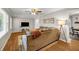 Cozy living room with hardwood floors, ceiling fan, and comfortable sofa at 2396 Midvale Cir, Tucker, GA 30084