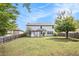 Large backyard with a wooden fence, a deck, and mature trees at 4440 Spring Mtn Ln, Powder Springs, GA 30127