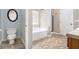 Bathroom with separate toilet area and combination bathtub and shower at 4440 Spring Mtn Ln, Powder Springs, GA 30127