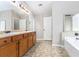 Bathroom with double vanity sinks and combination bathtub and shower at 4440 Spring Mtn Ln, Powder Springs, GA 30127