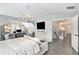 Bright bedroom features a chandelier, desk area, neutral color palette, and hardwood floors at 4440 Spring Mtn Ln, Powder Springs, GA 30127