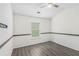 This bedroom offers ample natural light, sleek modern flooring, neutral walls, and a ceiling fan at 4440 Spring Mtn Ln, Powder Springs, GA 30127