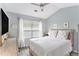 Comfortable bedroom with large window for natural light and neutral color palette at 4440 Spring Mtn Ln, Powder Springs, GA 30127