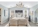 Comfortable bedroom features a chandelier, neutral color palette, and hardwood floors at 4440 Spring Mtn Ln, Powder Springs, GA 30127