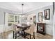 Dining room features modern lighting, wainscotting, and large window at 4440 Spring Mtn Ln, Powder Springs, GA 30127