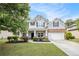 Charming two-story home with well-manicured lawn, landscaped flowerbeds and attached two-car garage at 4440 Spring Mtn Ln, Powder Springs, GA 30127