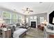 Spacious living room featuring a fireplace, ceiling fan and natural light at 4440 Spring Mtn Ln, Powder Springs, GA 30127