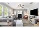 Bright living room with fireplace, large windows, and ceiling fan at 4440 Spring Mtn Ln, Powder Springs, GA 30127