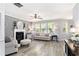 Bright living room boasts a fireplace and large windows with backyard views at 4440 Spring Mtn Ln, Powder Springs, GA 30127