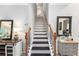 View of the carpeted staircase leading to the upper level at 4440 Spring Mtn Ln, Powder Springs, GA 30127
