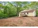 Backyard view of home with a wooden deck surrounded by lush trees for privacy and shade at 21 Misty Hollow Ct, Euharlee, GA 30145