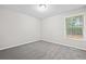Neutral bedroom featuring one window and new carpeting at 21 Misty Hollow Ct, Euharlee, GA 30145