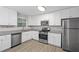 Contemporary kitchen featuring stainless steel appliances, granite countertops, and ample storage space at 21 Misty Hollow Ct, Euharlee, GA 30145