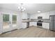 Modern kitchen with stainless steel appliances, white cabinets, and a view to the outdoor deck at 21 Misty Hollow Ct, Euharlee, GA 30145