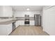 Modern kitchen with stainless steel appliances, white cabinets, and plenty of storage space at 21 Misty Hollow Ct, Euharlee, GA 30145