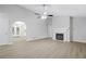 Bright, open living room with a fireplace, hardwood floors, and arched doorway to the kitchen at 21 Misty Hollow Ct, Euharlee, GA 30145